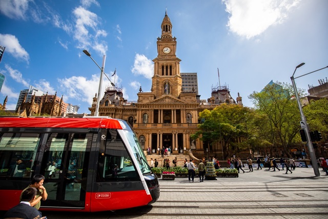 Light rail outside town hall on a sunny day