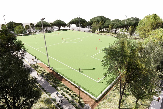 Artist’s impression shows soccer players on the field, which is surrounded by trees and people walking along footpaths around it.