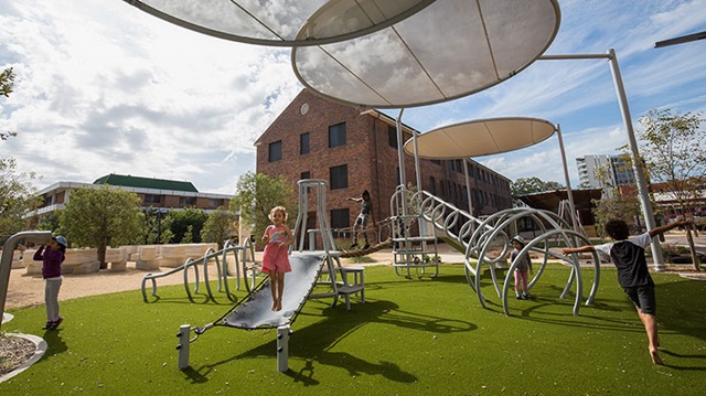 Children playing on playground equipment.