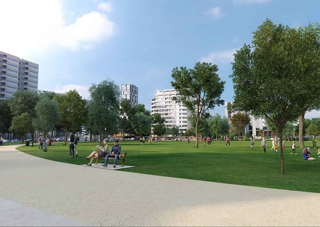 View of a park with trees, people sitting on a bench, and apartment buildings in the distance.