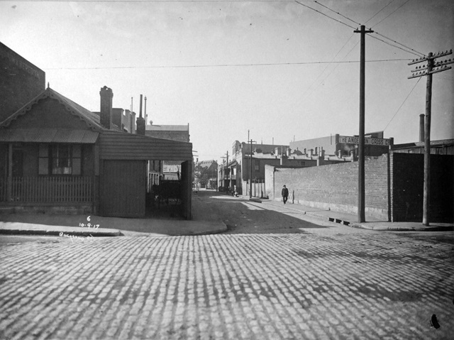 An historic photo of cobbled streets with buildings.