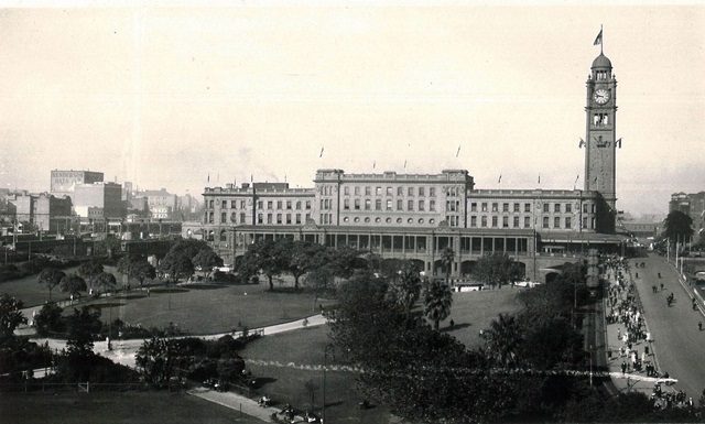 An historic photo of a train station and park.