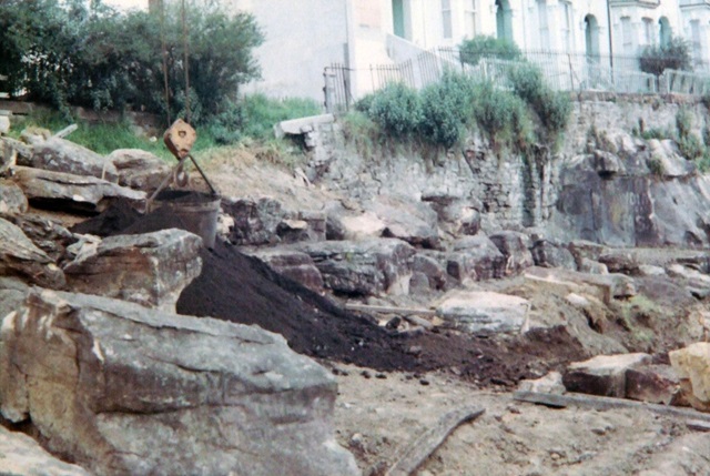 A park construction site with logs on the ground.