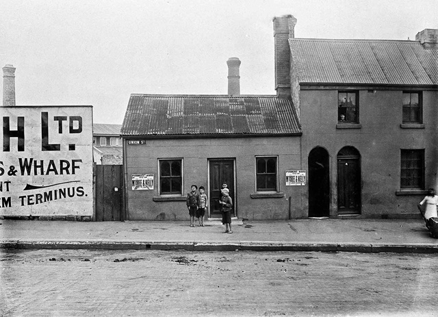 An historic photo of buildings and a road.
