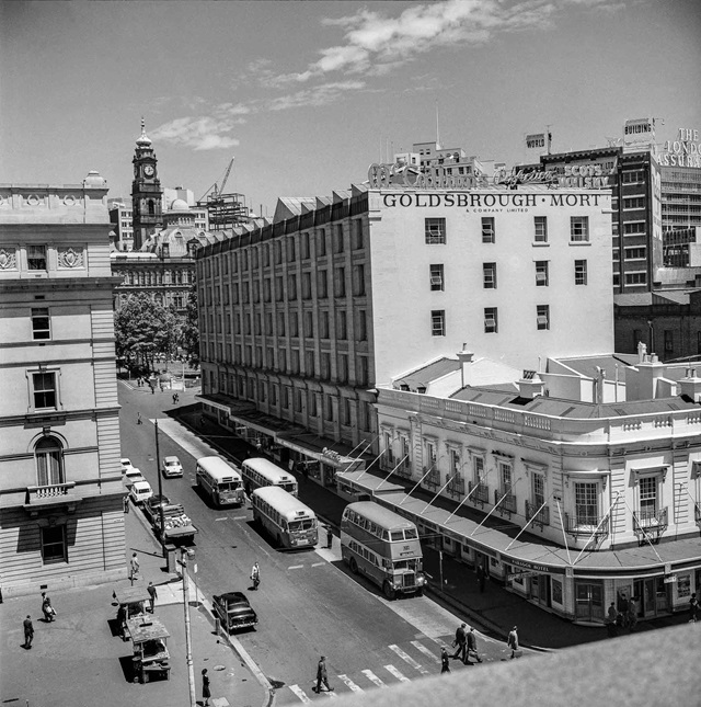 An historic photo of a road and buildings.