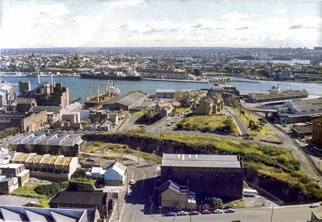 An aerial view of houses, grass and a river.