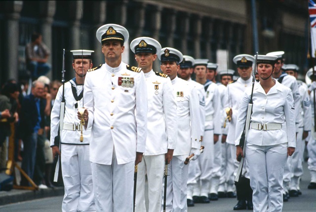 Men and women of the Royal Australian Navy marching in white uniform