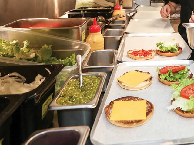 A line-up of trays filled with food.