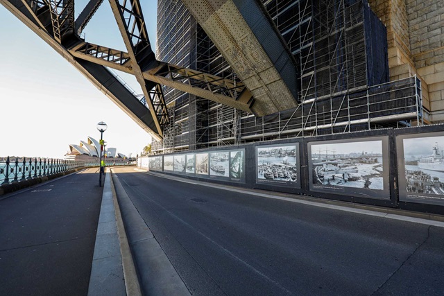 Historic photographs applied to boards on the base of the southern pylon of the harbour bridge.