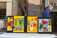 Colourful mural featuring cartoon-style animals, primarily koalas, with words like “Don’t Give Up” and “Koala Forever” painted on a construction hoarding.