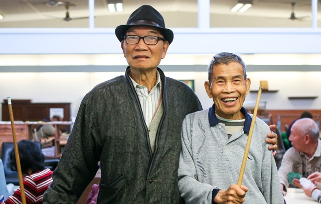 Man in hat with his arm around another man