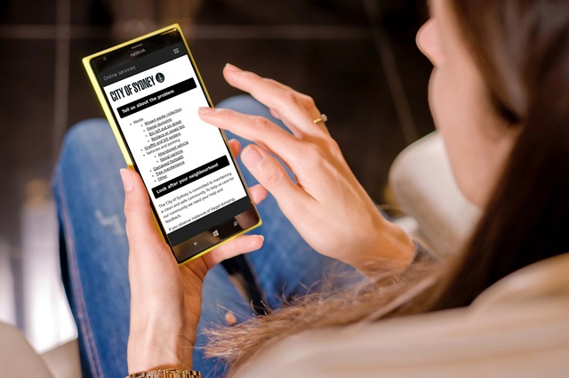 Woman looking at and touching mobile phone screen