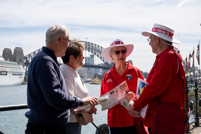 Two visitors speak with local guides