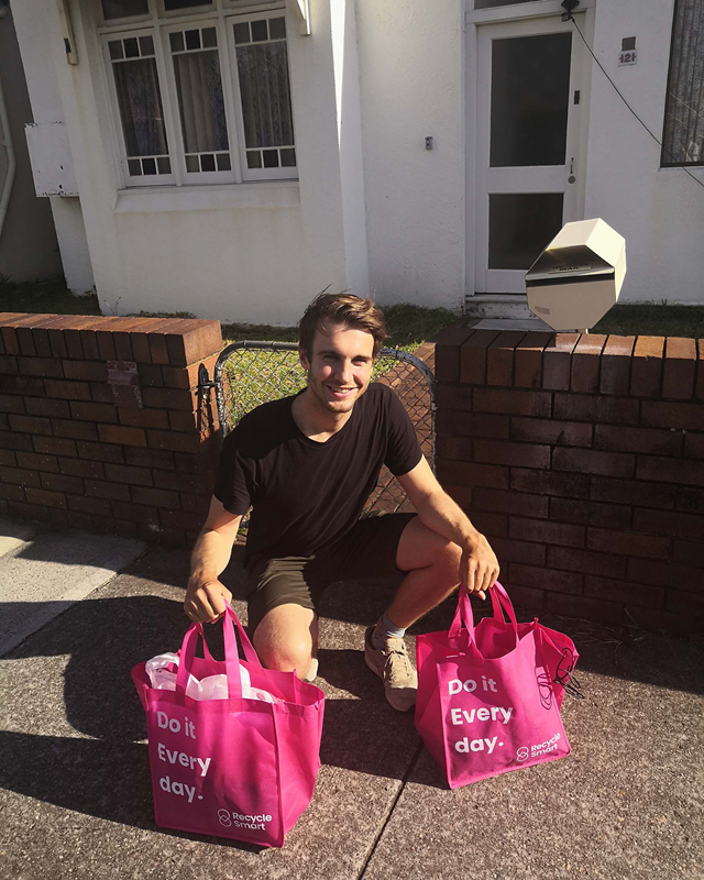 RecycleSmart driver carrying reusable shopping bag for collection.